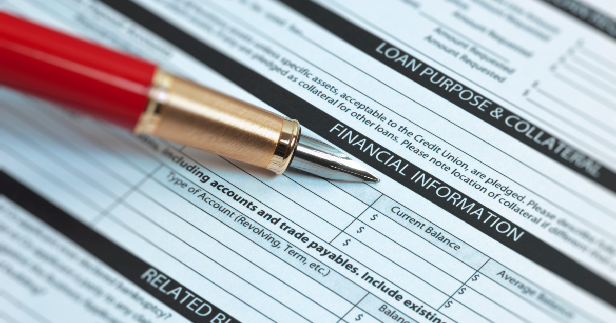 A Closeup Of A Red Fountain Pen, Angling In From The Upper Left Corner Of The Frame, Lying Across A Loan Application Form