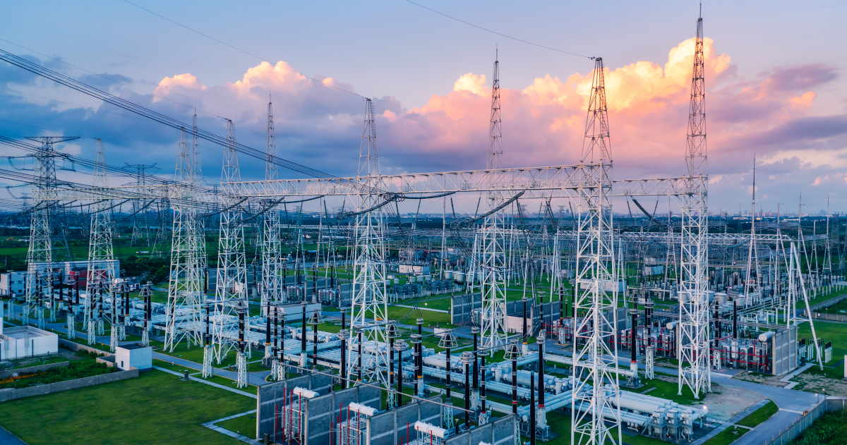 A Large Power Station, Seen From An Elevated Position And At An Angle, As The Sinking Sunk Stains A Raft Of Cumulus Clouds Orage Overhead