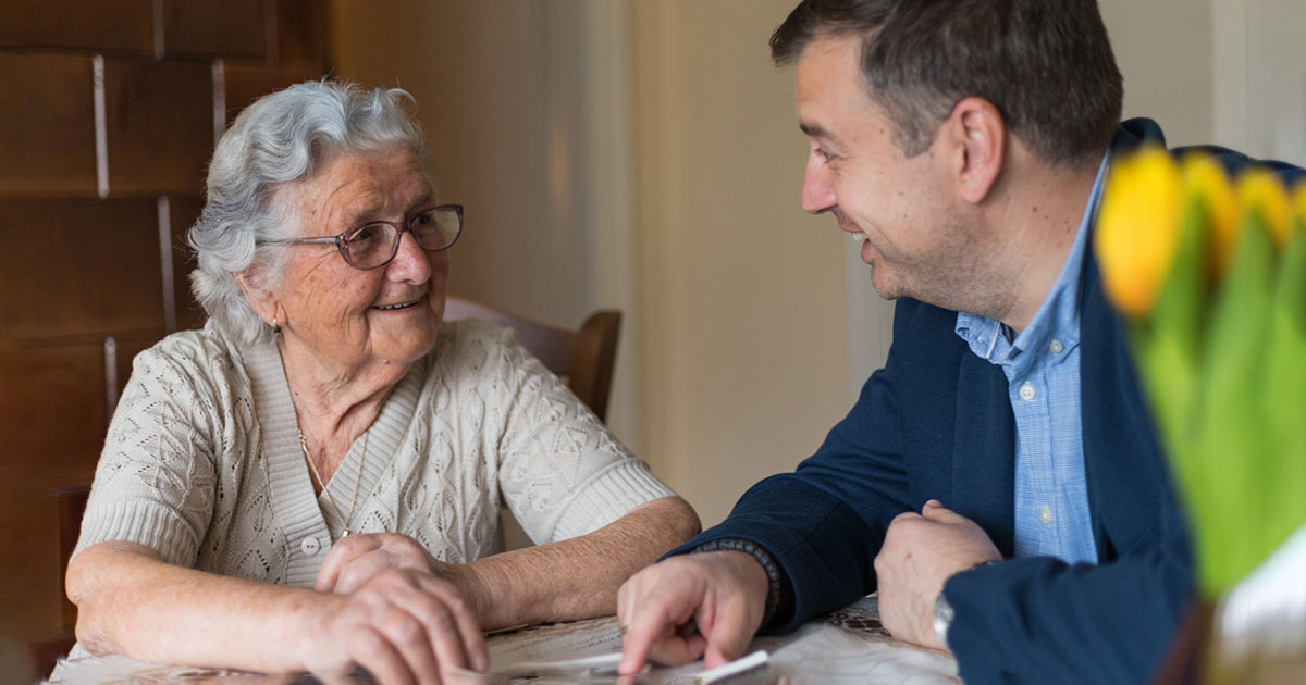 attorney shares a laugh with an elderly client
