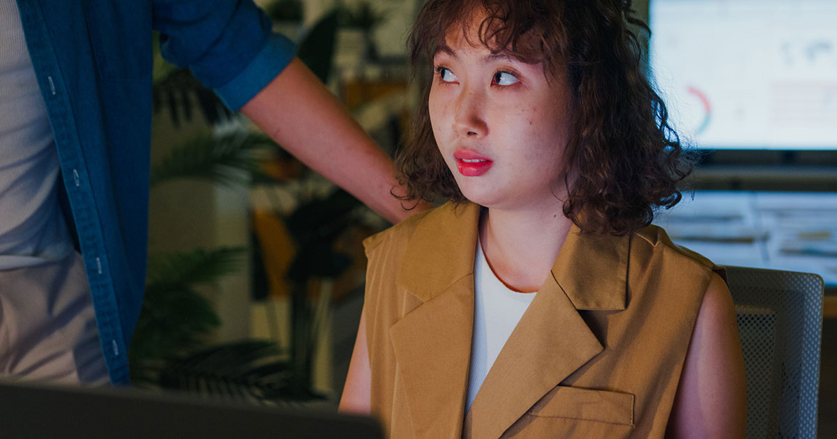 female worker appears worried at desk