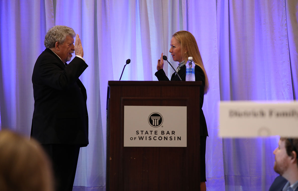 two people face each other behind a podium