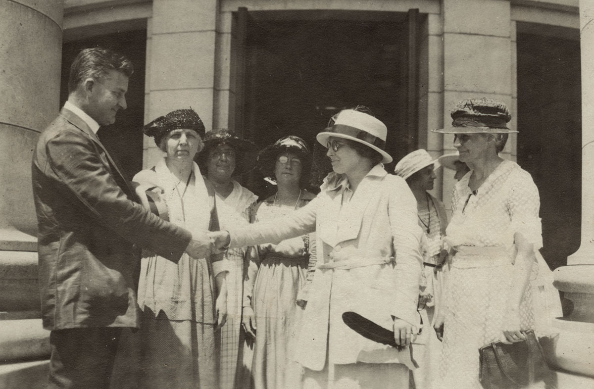 Gov. John J. Blain shakes the hand of Mabel Raef Putnam