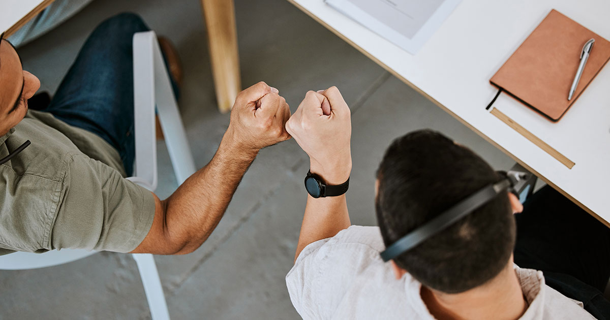 workers fist-bumping