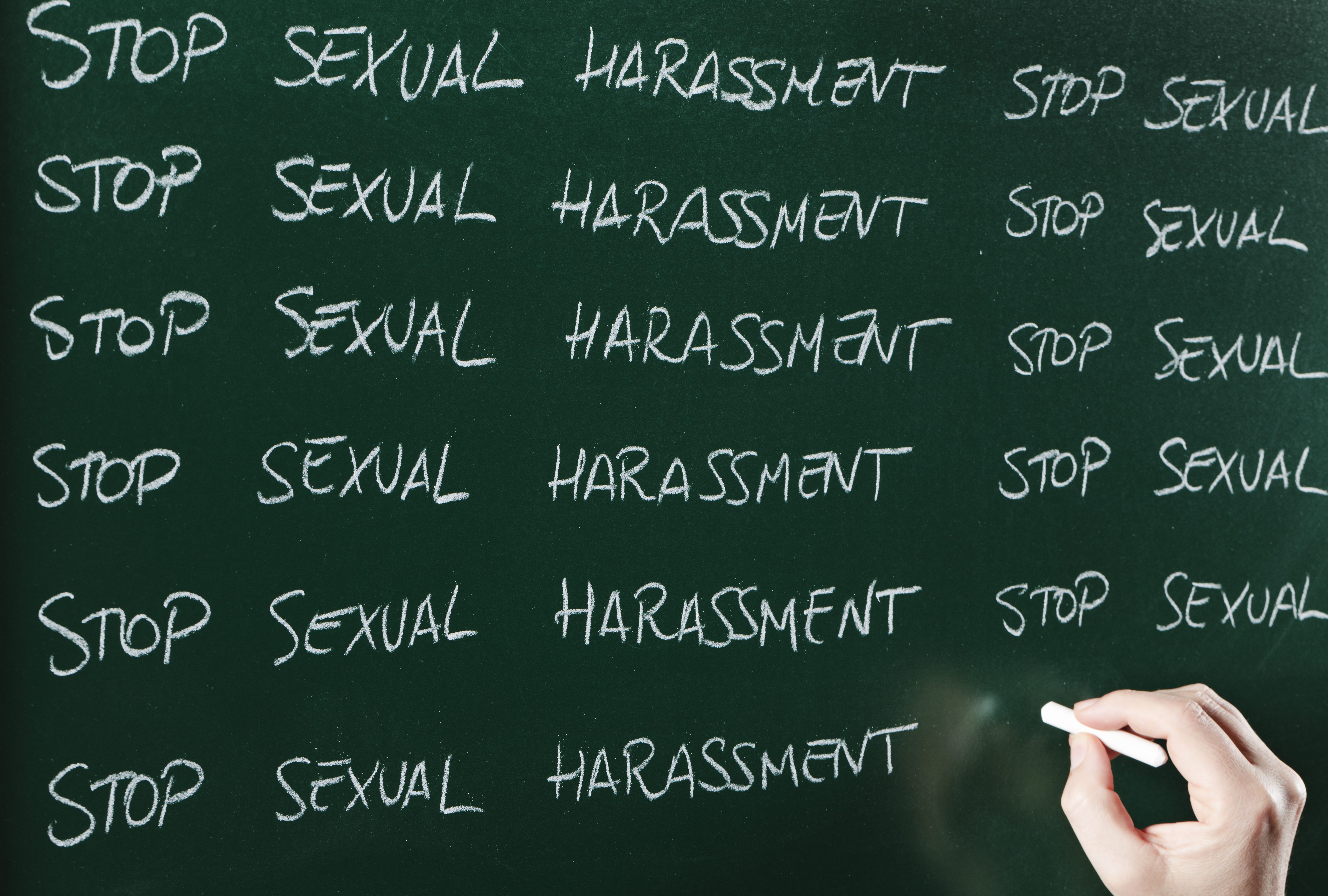 "Stop Sexual Harassment" written on a chalkboard.