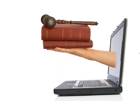 Hand reaching out of a laptop screen, holding books.